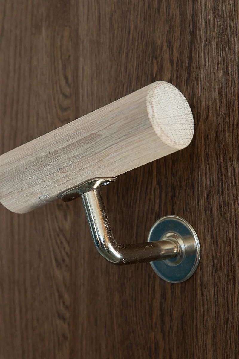 Light ash wooden handrail with stainless steel bracket