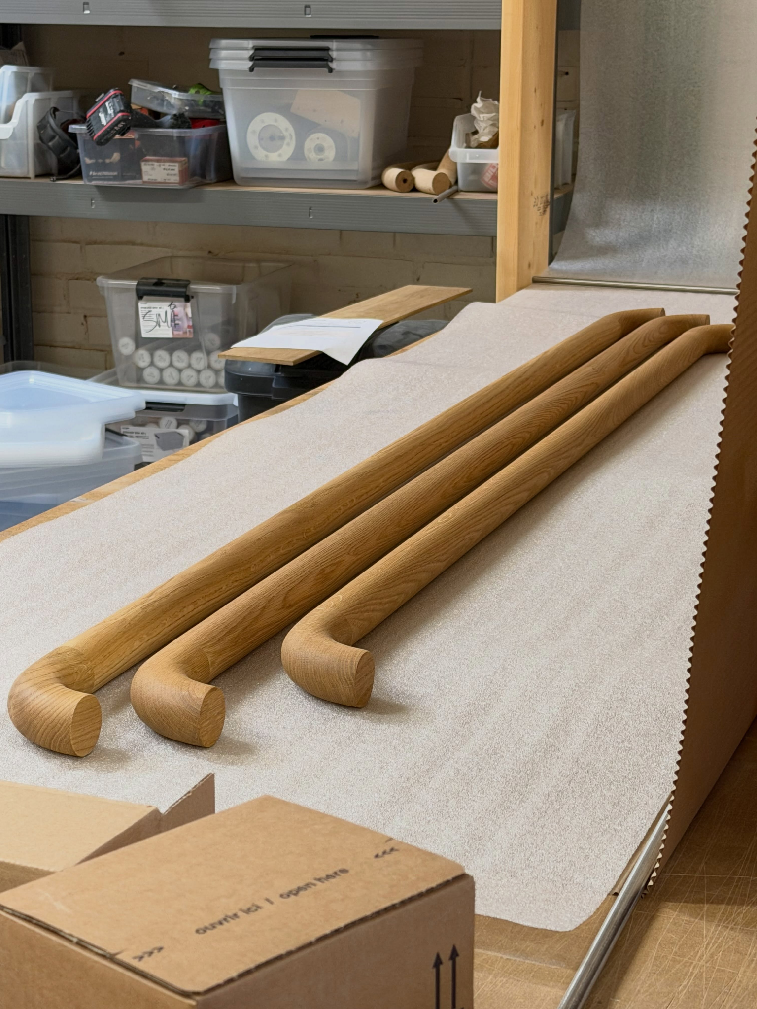 Curved and straight wooden handrails prepared in the workshop